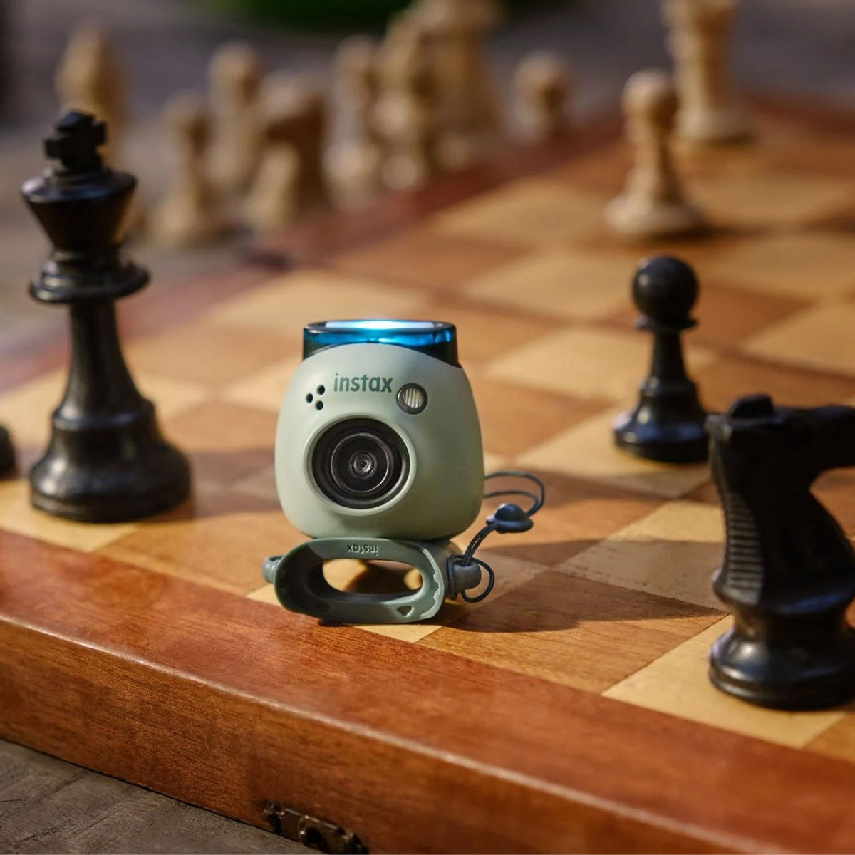 Instax PAL Digital Camera size comparison to chess piece
